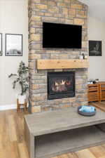 Interior details with light wood-type flooring and a fireplace