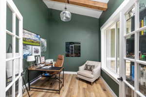 Office space featuring light hardwood / wood-style floors, french doors, and lofted ceiling with beams