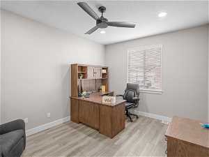 Office featuring light hardwood / wood-style floors, ceiling fan, and a textured ceiling