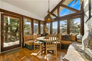 Sunroom featuring plenty of natural light and vaulted ceiling with beams