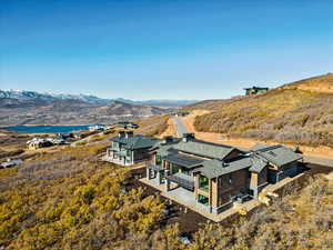 Birds eye view of property with a water and mountain view