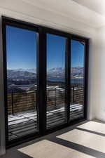 Doorway to outside featuring carpet flooring, a mountain view, and french doors