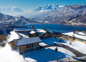 Snowy aerial view with a water and mountain view