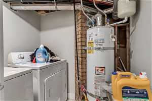 Utility room with independent washer and dryer and strapped water heater