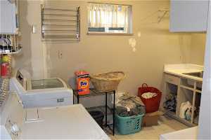 Spacious laundry room with light tile flooring.