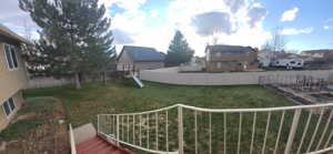 Fenced yard featuring a playground