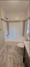Full bathroom with shower / washtub combination, toilet, tile floors, and vanity