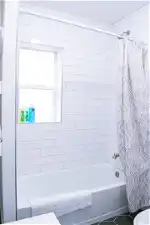 Bathroom featuring toilet, tile floors, and shower / bathtub combination with curtain