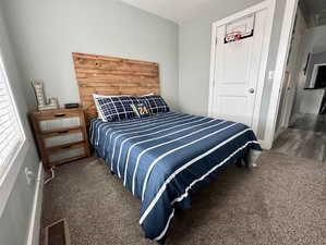 Bedroom featuring dark carpet