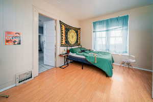 Bedroom with light wood-style floors