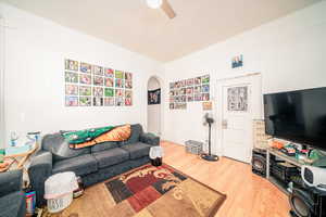 Living room featuring ceiling fan and light wood-type flooring