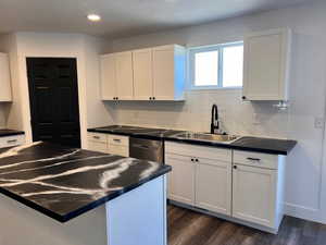 Kitchen featuring white cabinets, sink, and dark hardwood / wood-style flooring