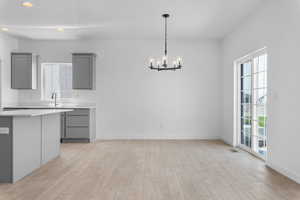 Unfurnished dining area with light hardwood / wood-style floors, a chandelier, and plenty of natural light