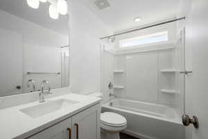 Full bathroom featuring vanity, shower / washtub combination, and toilet