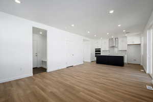 Unfurnished living room featuring light hardwood / wood-style floors