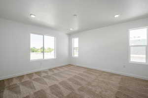 Spare room featuring light colored carpet