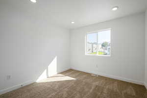 Unfurnished room with carpet floors