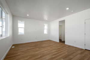 Spare room with hardwood / wood-style floors and a wealth of natural light