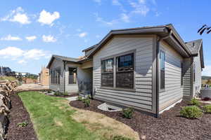 View of front of property featuring a front lawn and cooling unit