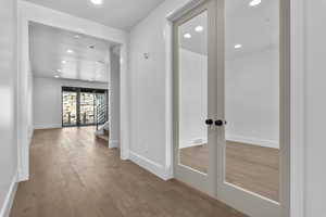 Corridor featuring hardwood / wood-style flooring and french doors