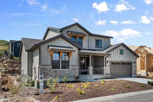 View of front of property featuring a porch and a garage