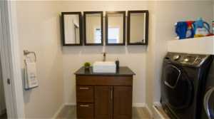 Bathroom vanity and sink next to the washer and dryer