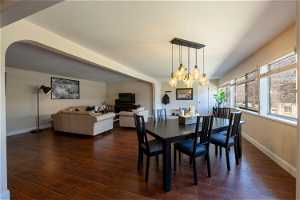 Open Dining - Living area featuring an inviting chandelier and dark wood-type flooring