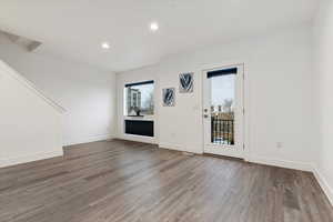 Empty room featuring dark wood-type flooring