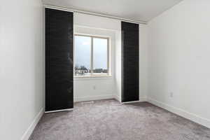 Spare room with light colored carpet