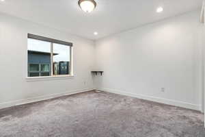 Unfurnished room with carpet flooring