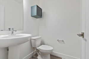 Bathroom featuring toilet and wood-type flooring