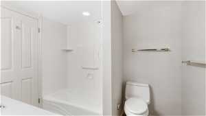 Bathroom with toilet and shower / bathing tub combination