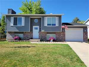Split Level  home featuring a front lawn, attached one car garage, in quiet cut-du-sac