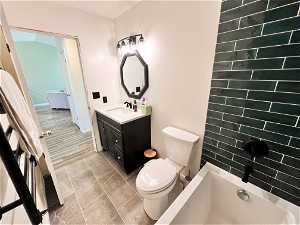 Full bathroom featuring beautiful tile finishes, modern tub design, and heated towel warmer.