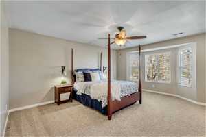 Bedroom with ceiling fan and light colored carpet
