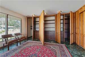 Office/Library View of Hidden Panelled bookshelves and drawers.