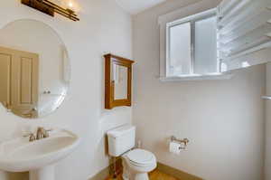 Bathroom featuring hardwood / wood-style floors, sink, and toilet