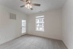 Unfurnished room featuring ceiling fan and carpet