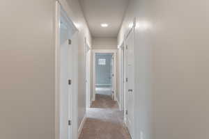 Corridor with light colored carpet