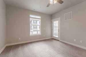 Unfurnished room with ceiling fan, carpet, and a textured ceiling