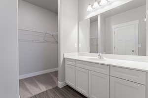 Bathroom with vanity and hardwood / wood-style floors