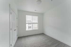 Empty room featuring carpet floors