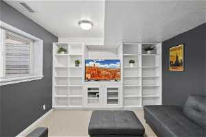 Living room with built in shelves and entertainment center