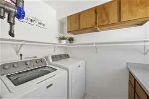 Laundry room with cabinets and independent washer and dryer