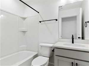 Full bathroom featuring shower / bath combination, large vanity, and toilet