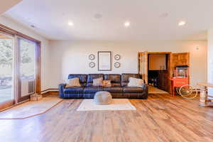 Living room with a wealth of natural light and light wood-type flooring