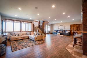 Living room with light hardwood / wood-style floors and a healthy amount of sunlight