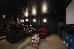 Home theater room with carpet flooring