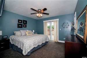 2018 Staging Photo: Carpeted bedroom with ceiling fan, access to outside, and a textured ceiling