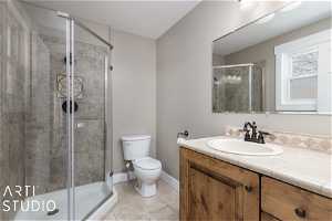 Bathroom with toilet, tile floors, an enclosed shower, and vanity